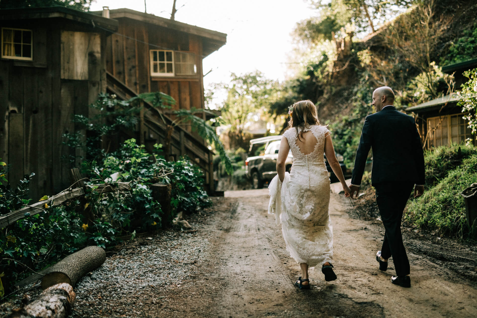 Des Moines Wedding Photographers A couple walking before their elopement at Deetjens Inn in Big Sur, California