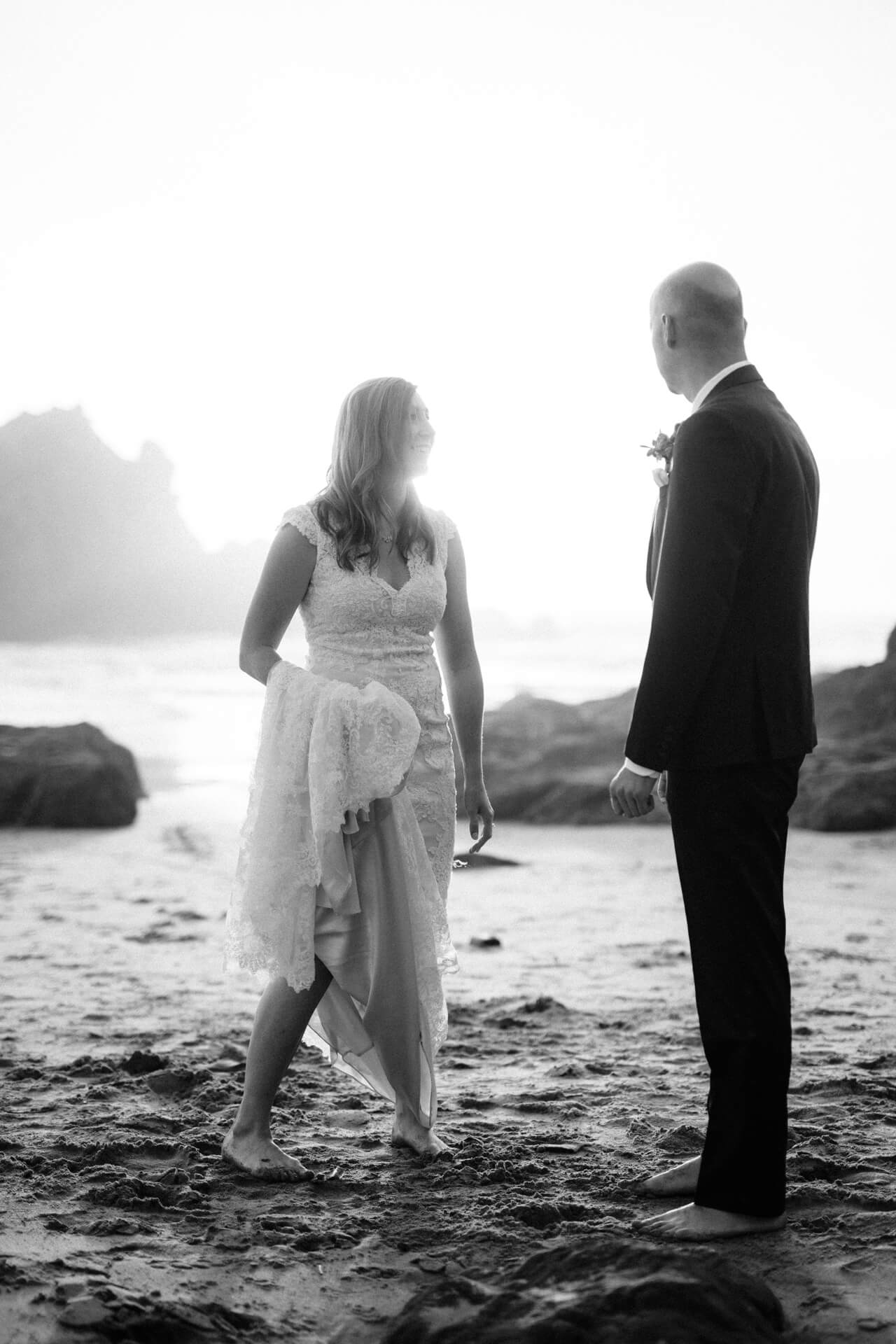Des Moines Wedding Photographers A couple eloping on the beach in Big Sur, California