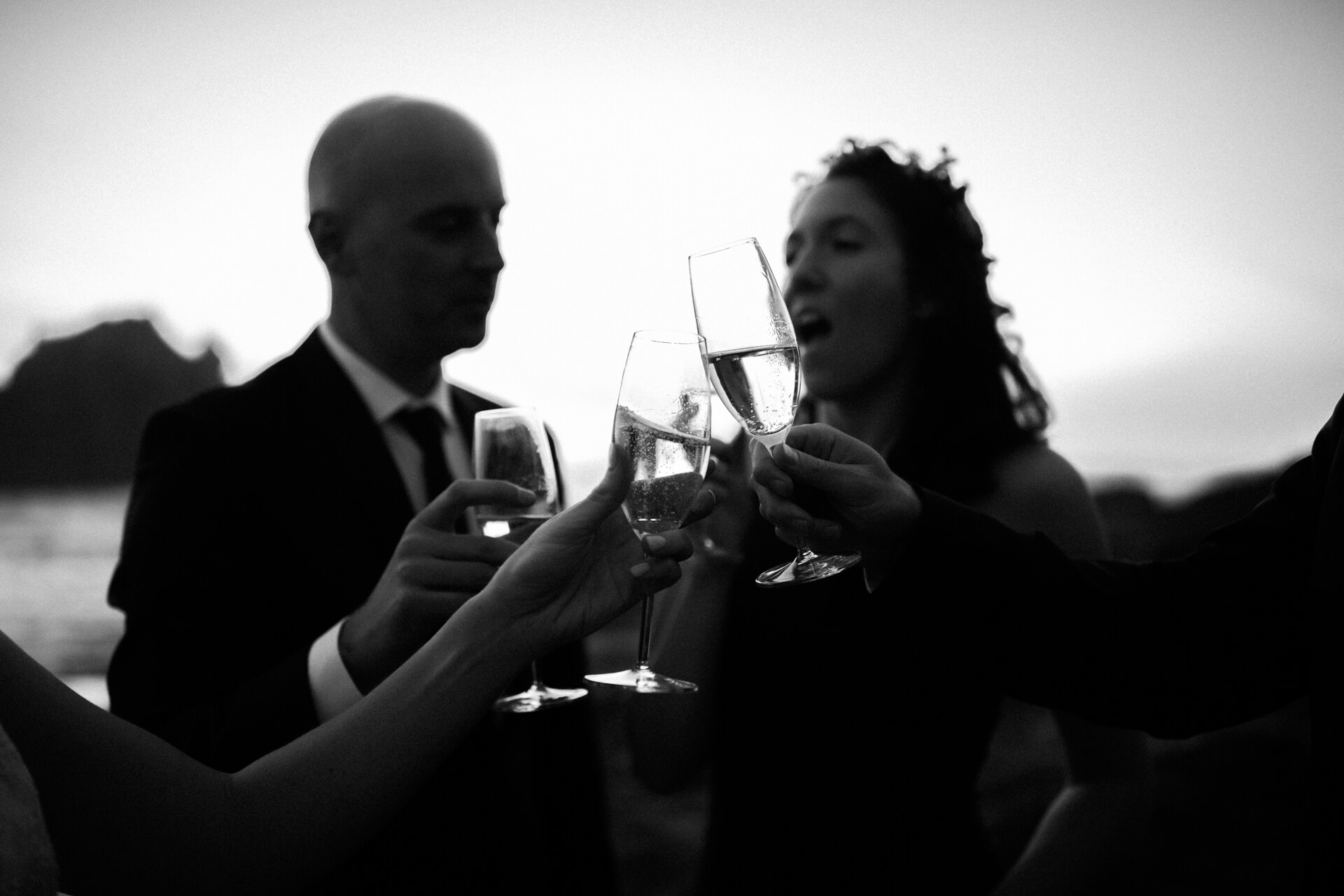 Des Moines Wedding Photographers A Big Sur Pfeiffer Beach toast after the elopement