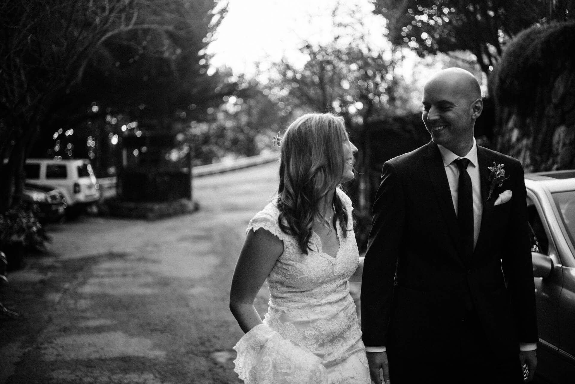 Des Moines Wedding Photographers A couple walking before their elopement at Deetjens Inn in Big Sur, California