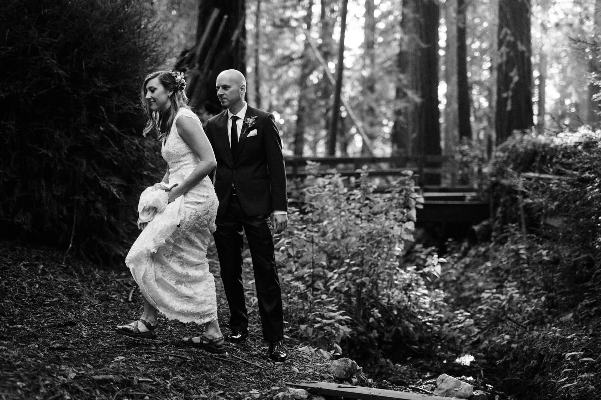 Des Moines Wedding Photographers A couple walking before their elopement at Deetjens Inn in Big Sur, California